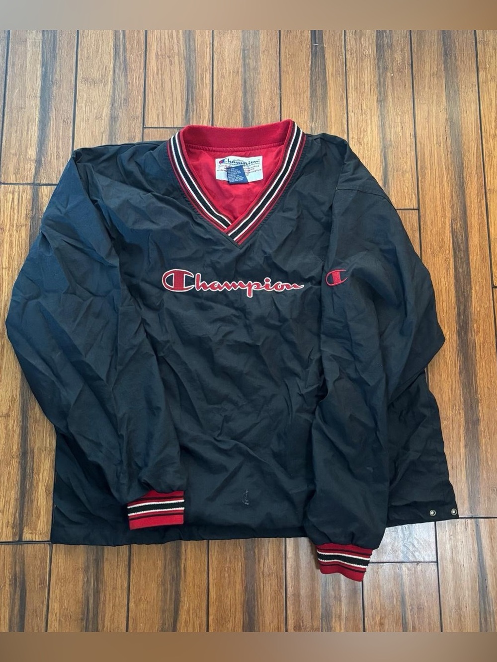 black windbreaker jacket with red collar and white stripes - champion